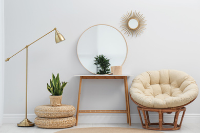 Photo of Stylish round mirror near white wall in room
