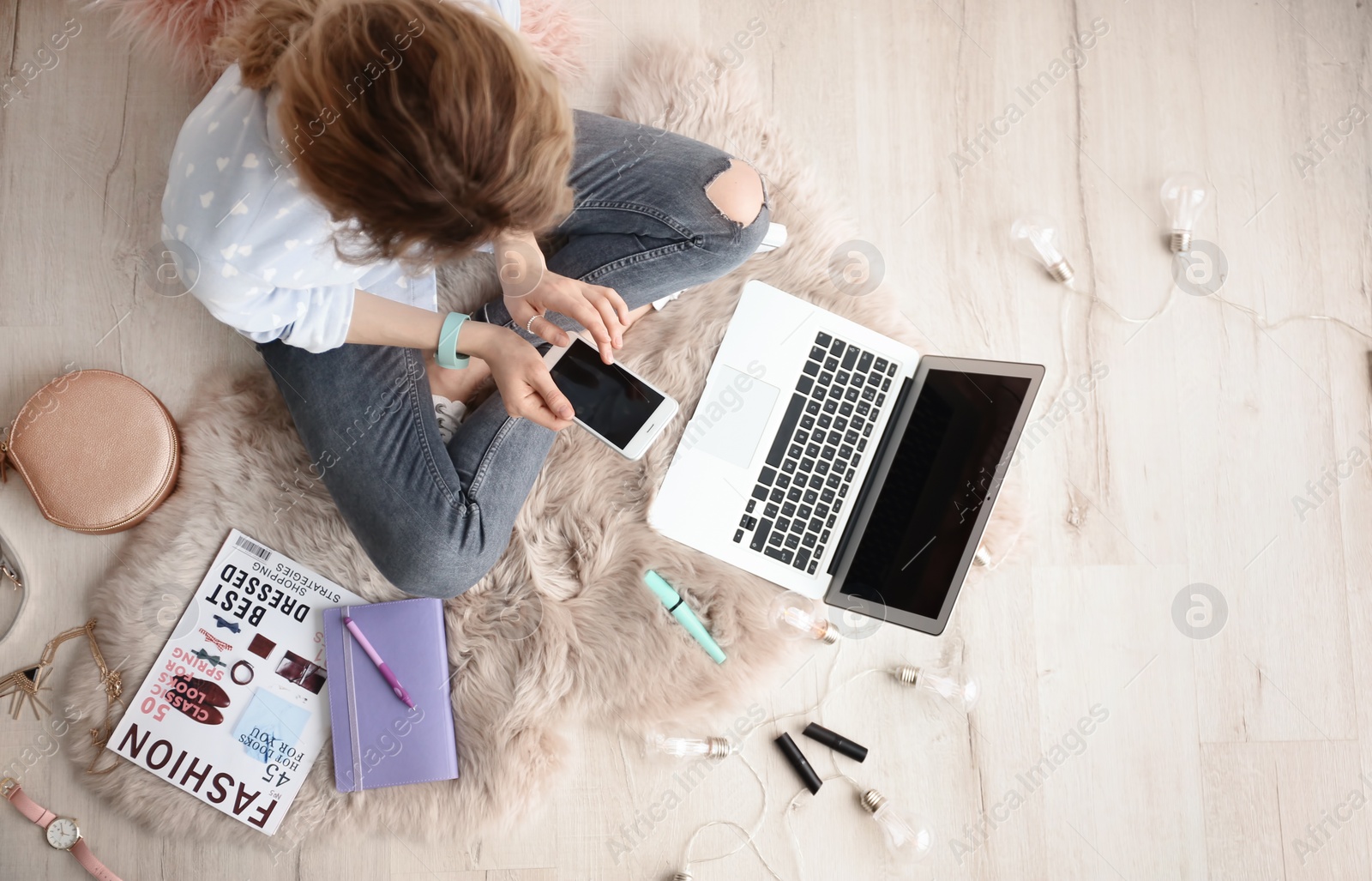 Photo of Female beauty blogger with smartphone and laptop indoors, top view