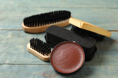 Composition with shoe care accessories on wooden background, closeup