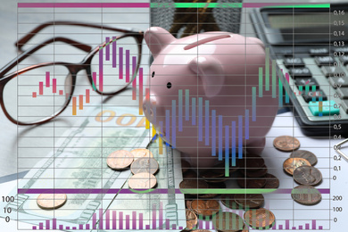 Image of Finance trading concept. Piggy bank with coins on table and chart