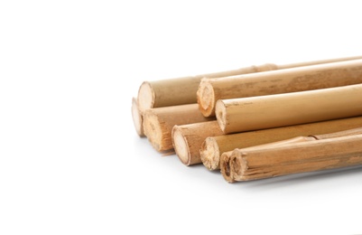 Pile of dry bamboo sticks on white background