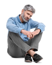 Photo of Mature businessman in stylish clothes sitting on white background