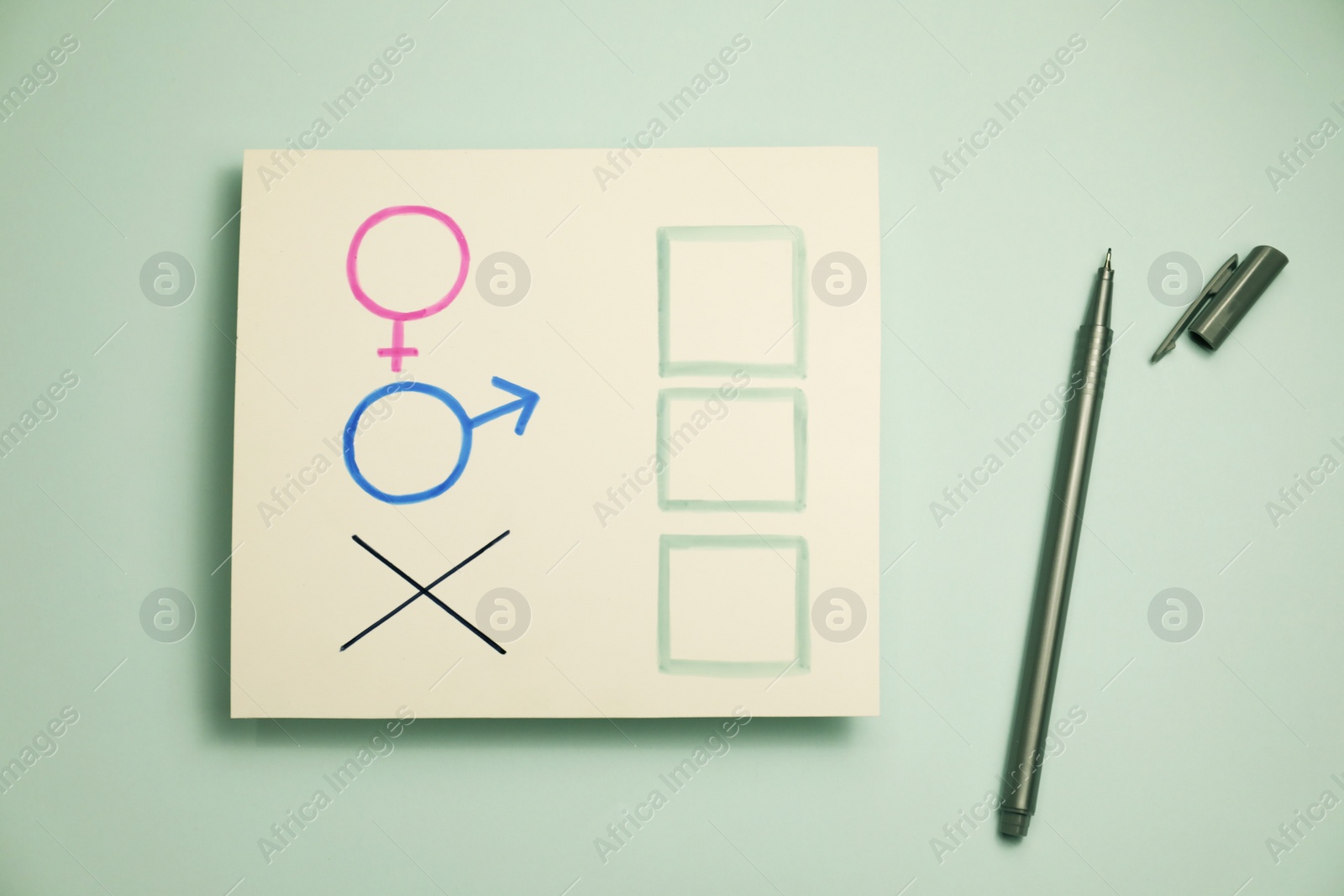 Photo of Gender equality. Pen near card with cross mark, male and female symbols on light grey background, flat lay