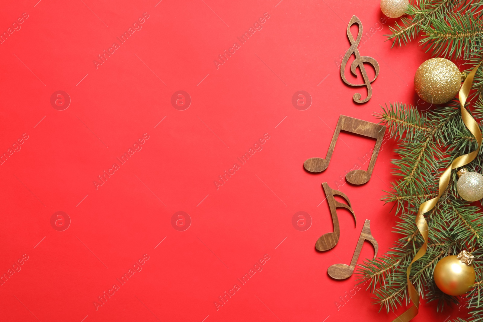 Photo of Flat lay composition with decorations and  notes on color background. Christmas music concept