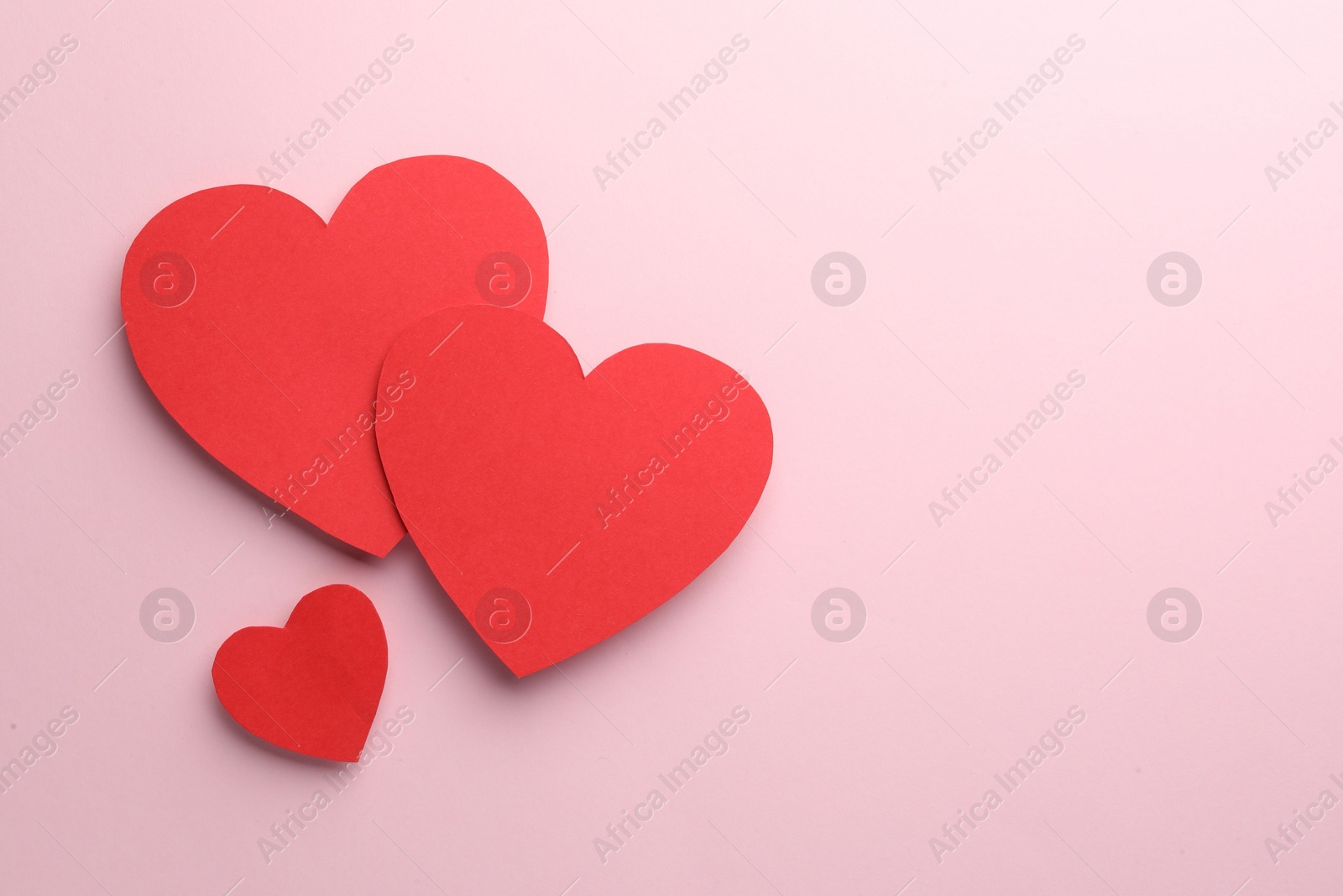 Photo of Paper hearts on pink background, flat lay. Space for text