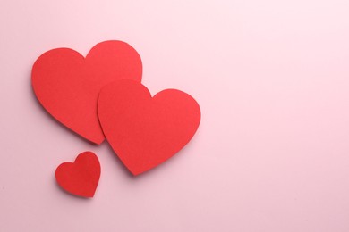 Photo of Paper hearts on pink background, flat lay. Space for text