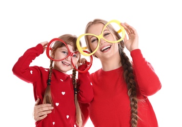 Photo of Happy woman and daughter with funny glasses on white background