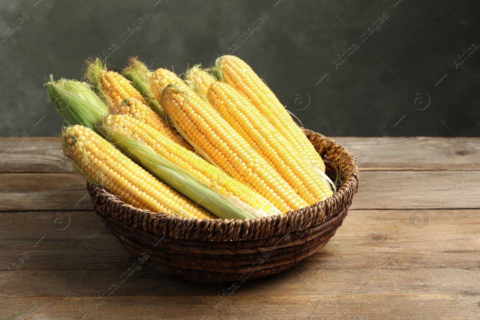 Photo of Tasty sweet corn cobs on wooden table