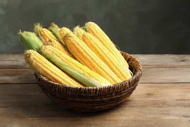 Tasty sweet corn cobs on wooden table