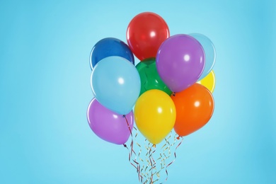 Photo of Bunch of bright balloons on color background