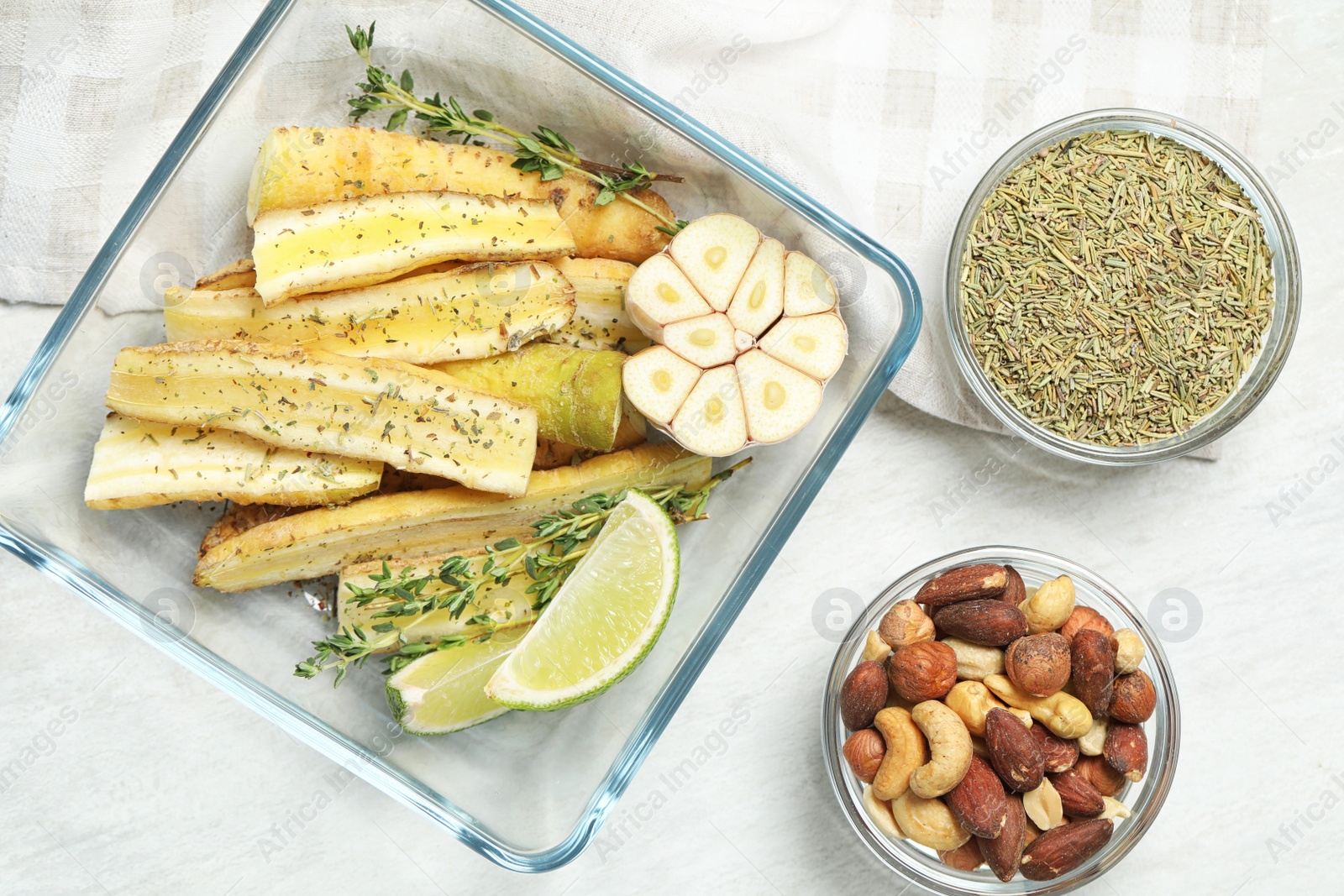 Photo of Flat lay composition with raw cut white carrot in baking dish on wooden table