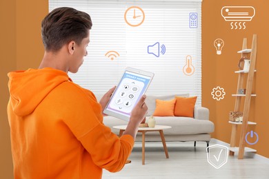 Man using smart home control system via application on tablet indoors. Different icons near him