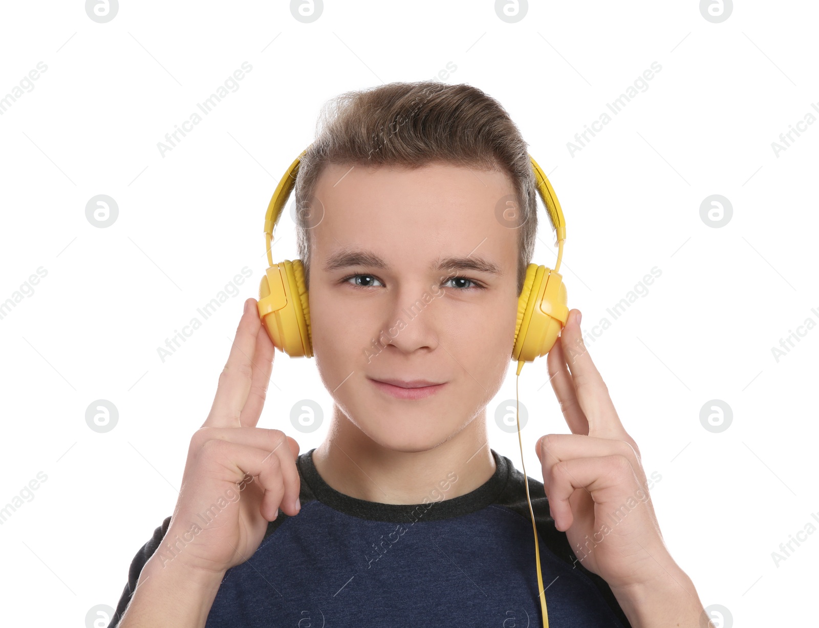 Photo of Teen boy listening to music with headphones on white background