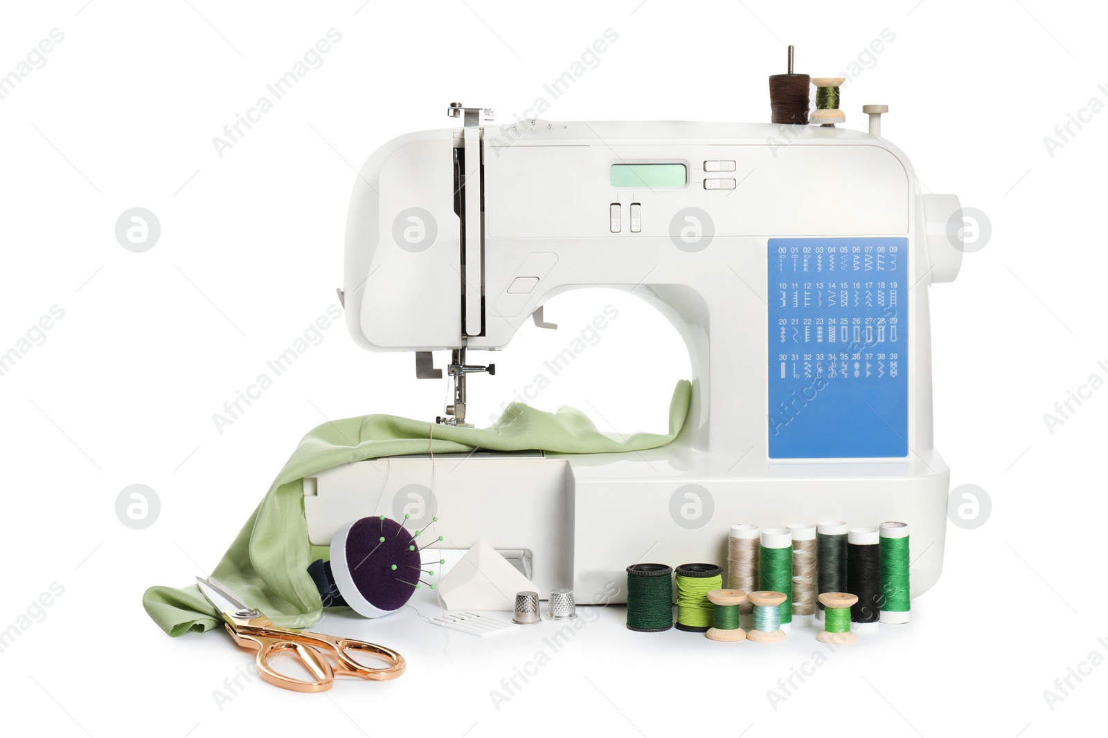 Photo of Modern sewing machine with light green cloth and craft accessories isolated on white