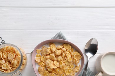 Photo of Tasty cornflakes with milk served on white wooden table, flat lay. Space for text