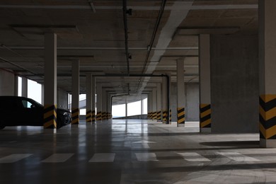Photo of Modern car in parking garage with pedestrian crossing