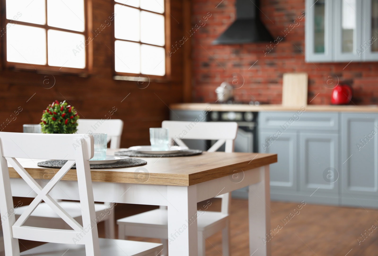 Photo of Stylish kitchen interior with dining table and chairs