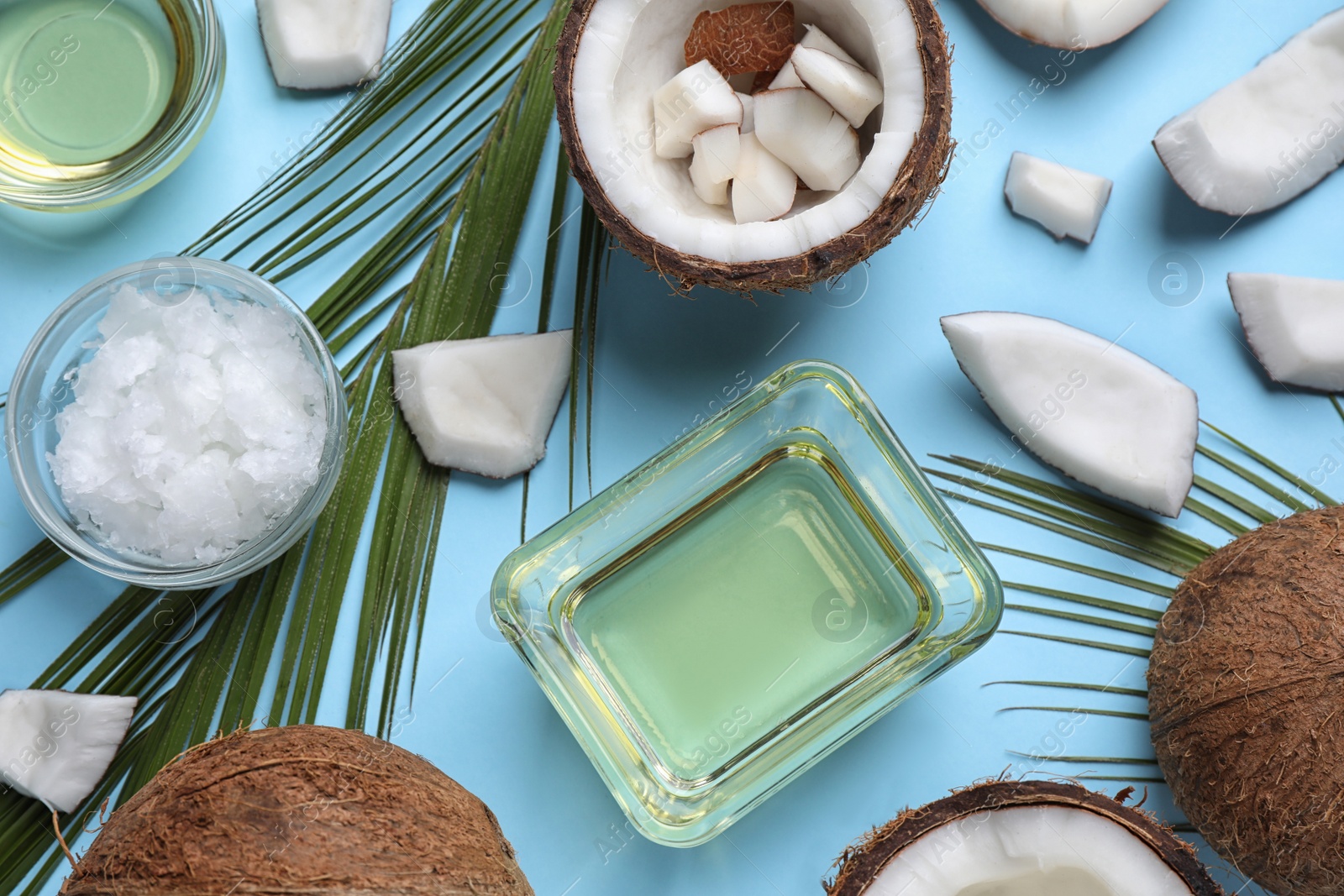 Photo of Flat lay composition with coconut oil on light blue background