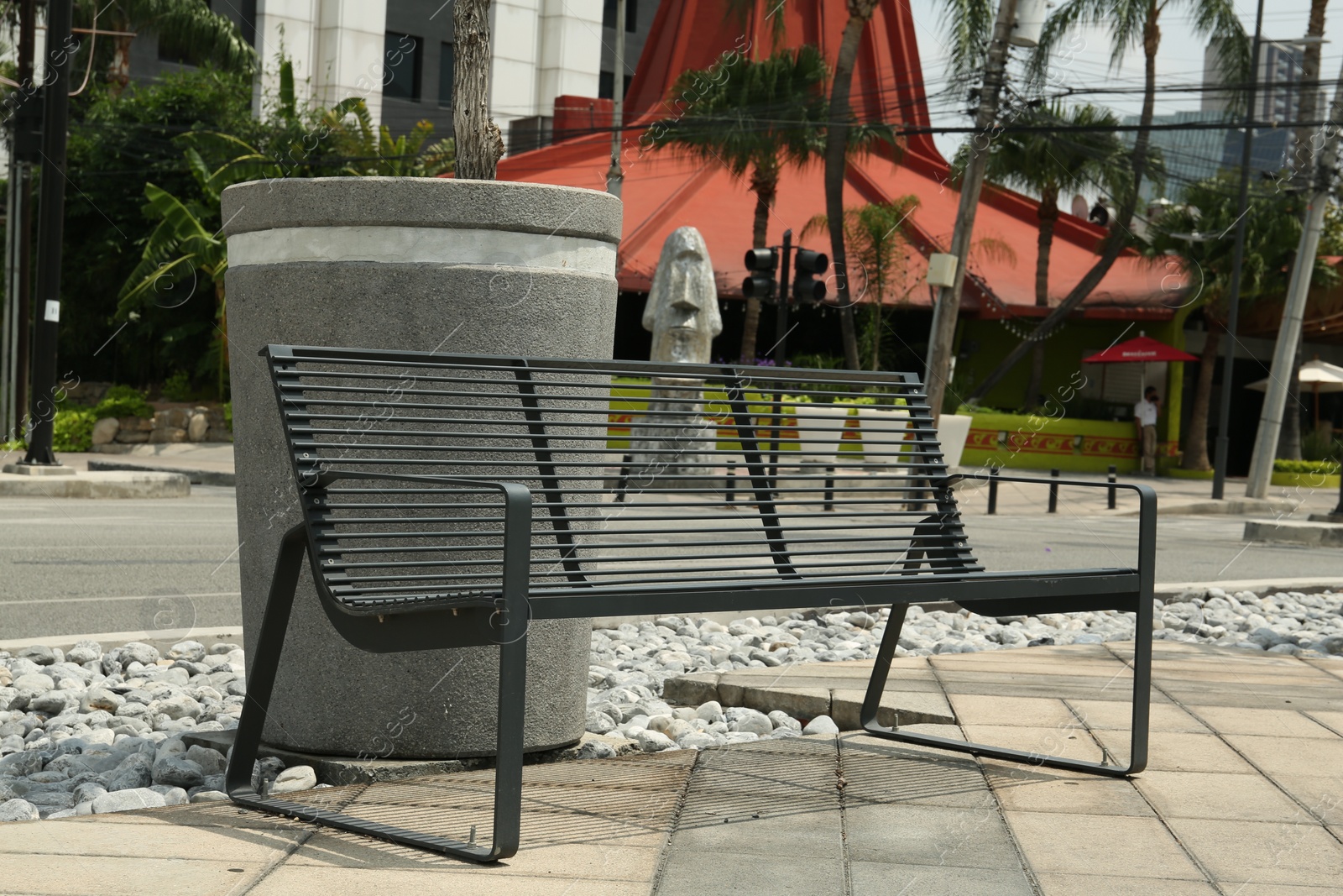 Photo of Stylish metal bench in park on sunny day