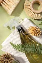 Photo of Flat lay composition with different cleaning supplies on green background