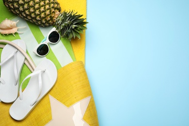 Flat lay composition with beach accessories on color background. Space for text