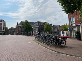 Beautiful view of parking with bicycles and buildings on city street