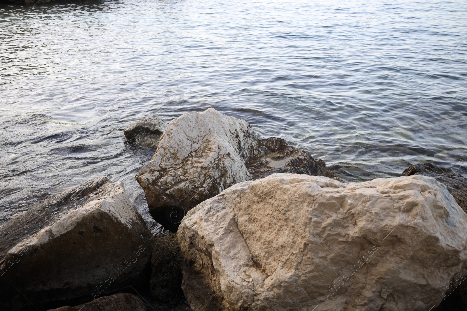 Photo of Beautiful view of sea coast with stones on summer day