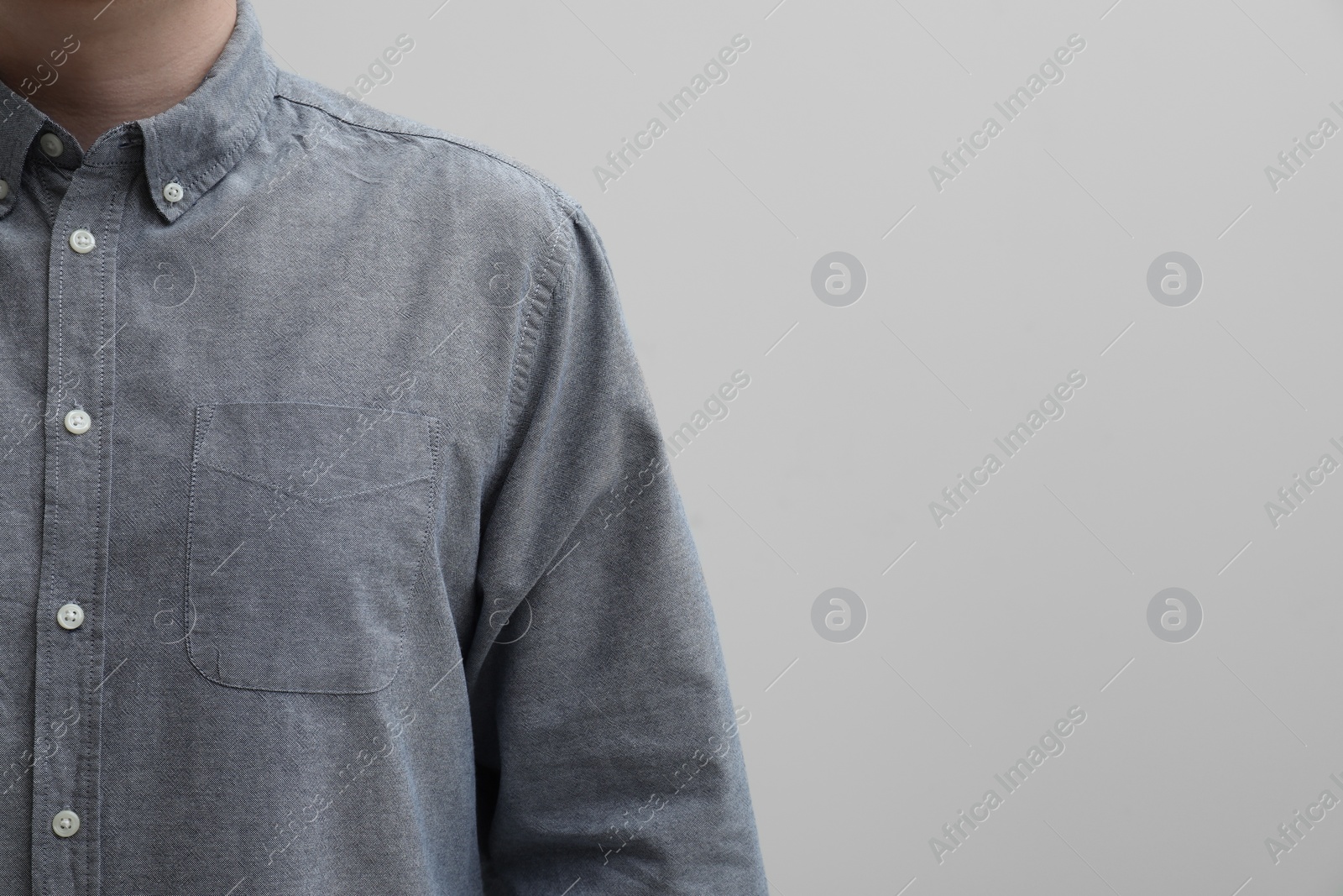 Photo of Man wearing clean shirt on white background, closeup. Space for text