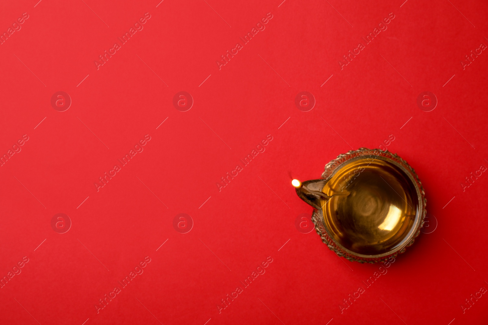Photo of Diwali diya or clay lamp on color background, top view