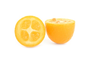 Halves of fresh ripe kumquat on white background
