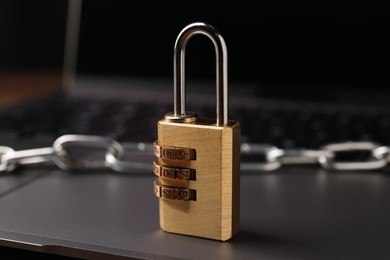 Photo of Cyber security. Padlock on laptop, closeup view