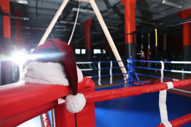 Santa hat in corner of boxing ring. Space for text