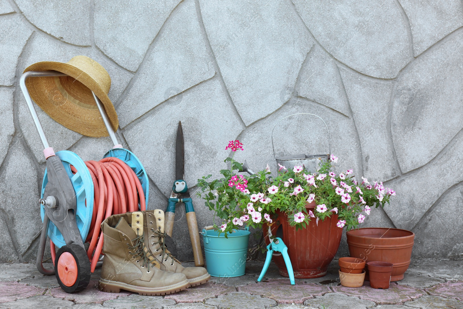 Photo of Set of gardening tools near wall outdoors