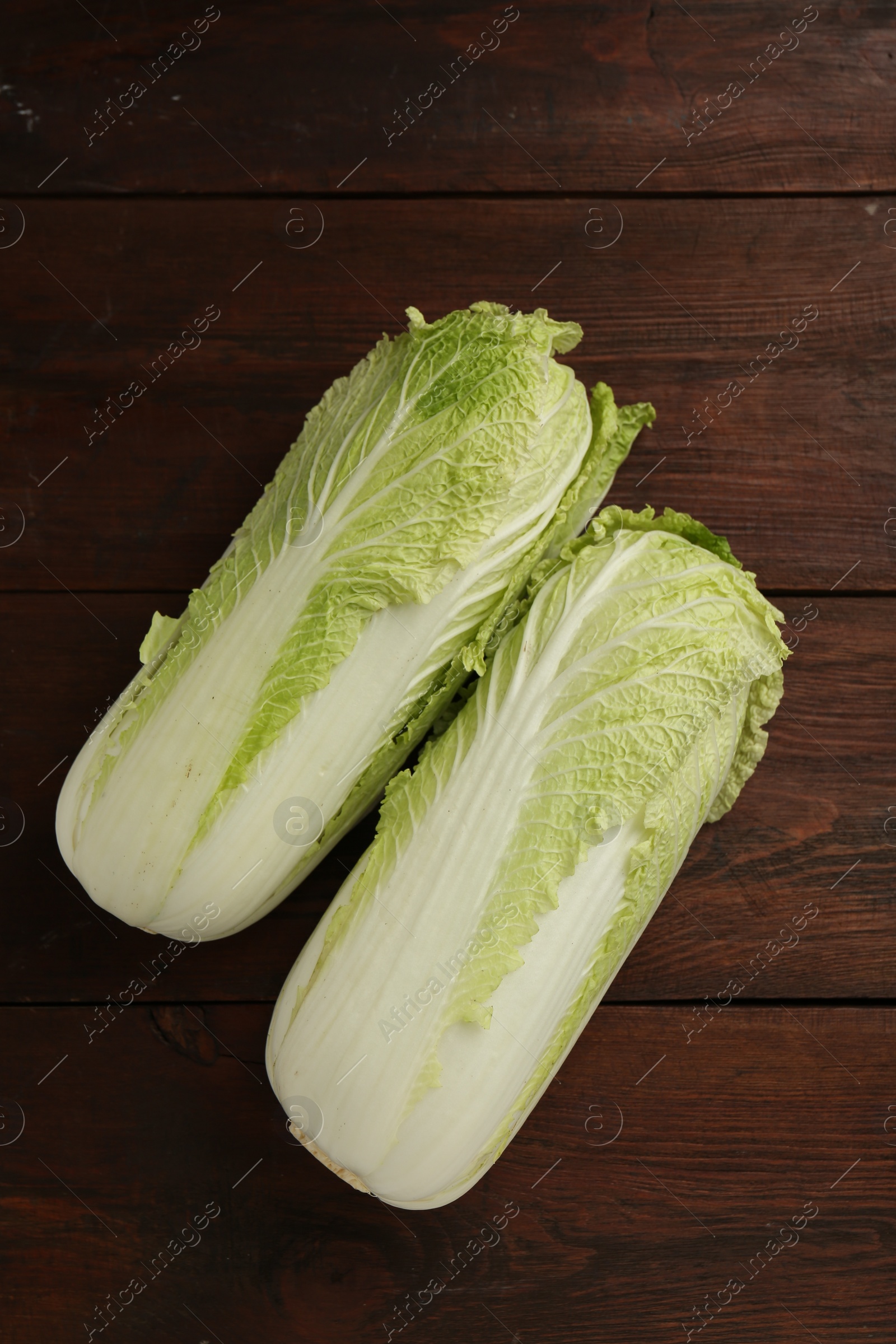 Photo of Fresh ripe Chinese cabbages on wooden table, top view