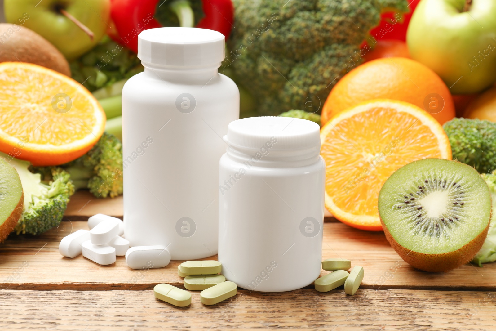 Photo of Dietary supplements. Plastic bottles, pills, and food products on wooden table