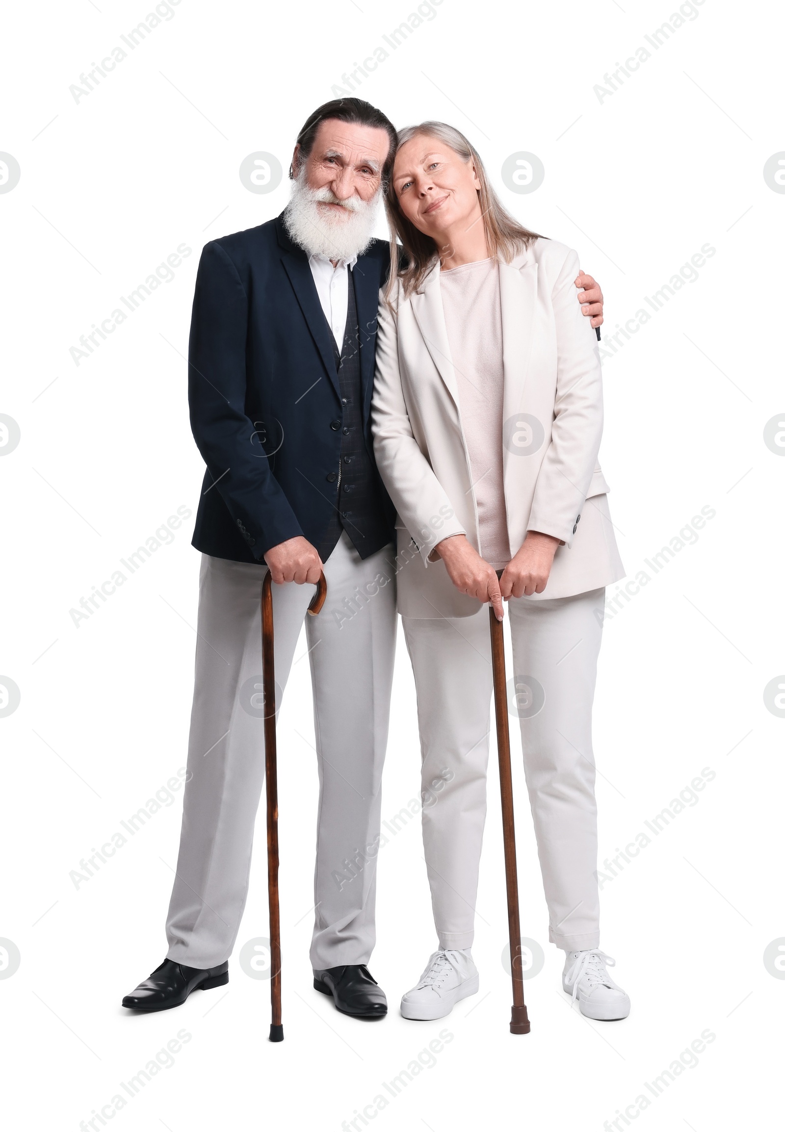 Photo of Senior man and woman with walking canes on white background