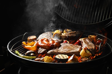 Photo of Assorted delicious meat and vegetables on barbecue grill