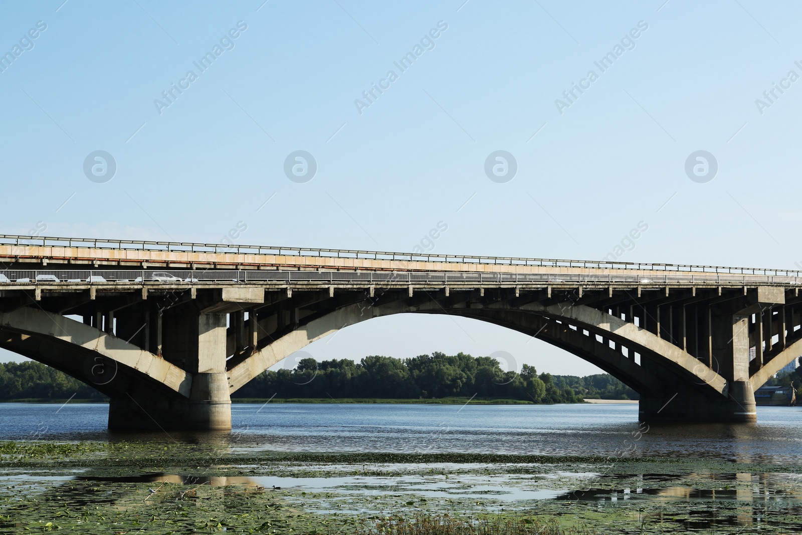 Photo of Beautiful view of arch bridge over river on sunny day