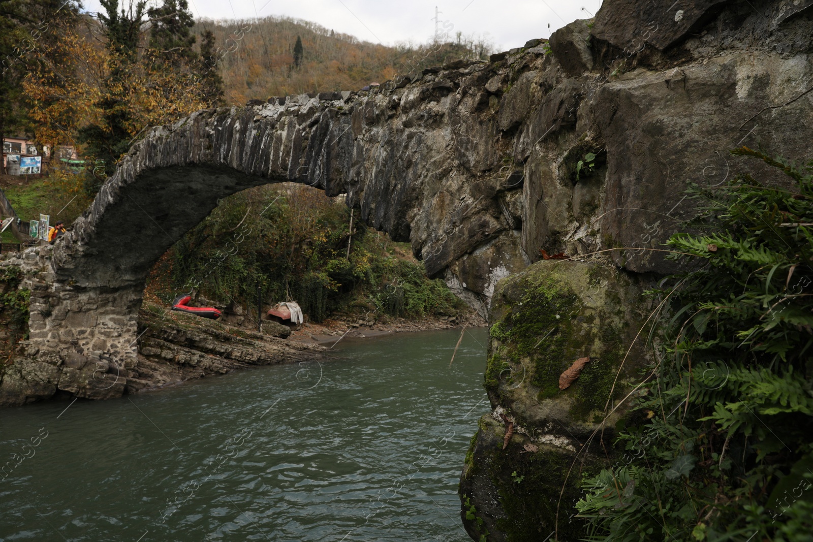 Photo of Adjara, Georgia - November 19, 2022: Picturesque view of stone arched bridge over Acharistskali river in mountains