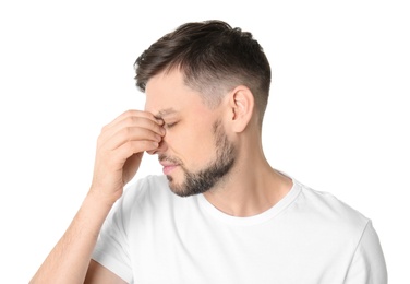 Man suffering from headache on white background