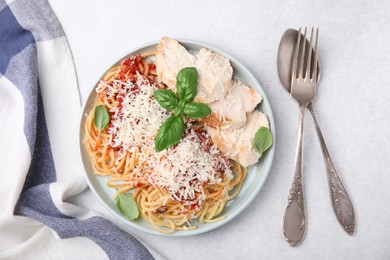 Photo of Delicious pasta with tomato sauce, chicken and parmesan cheese on white table, flat lay
