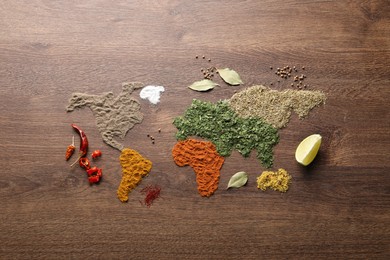 Photo of World map of different spices on wooden table, flat lay