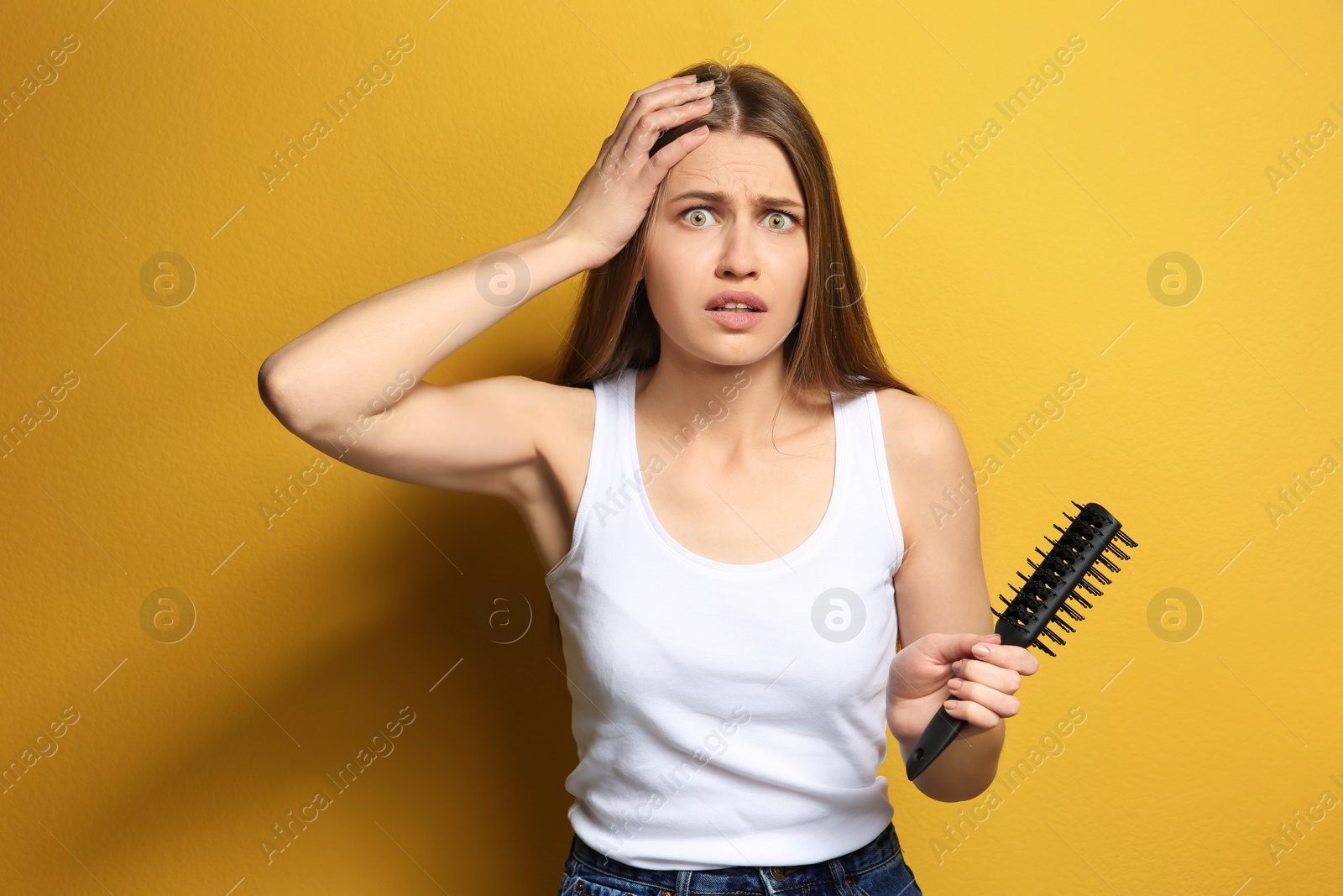 Photo of Young woman with hair loss problem on color background