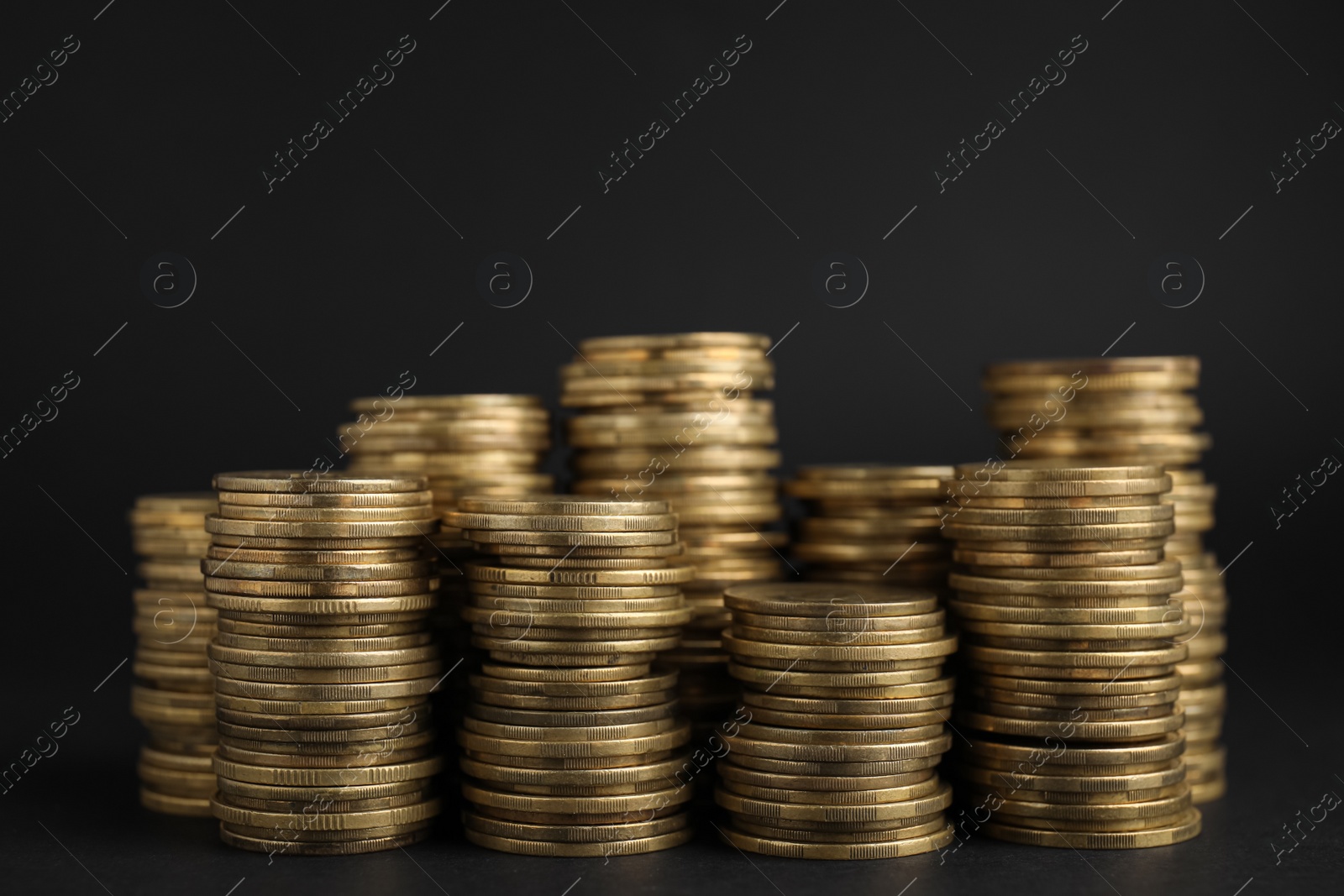 Photo of Many Euro coins stacked on black background