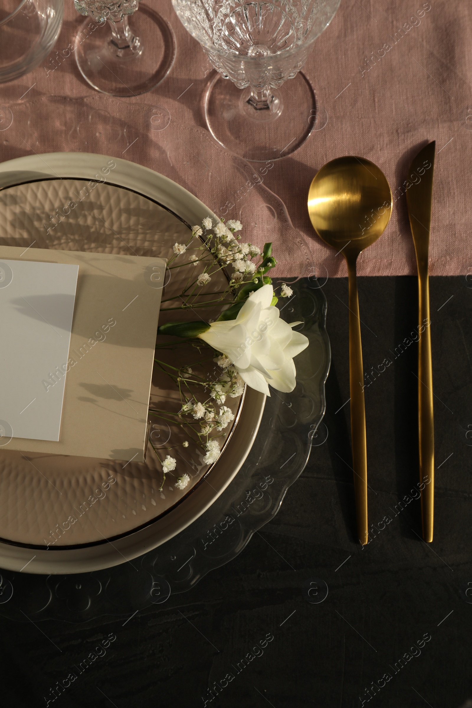 Photo of Stylish table setting. Plates, cutlery, blank card and floral decor, flat lay