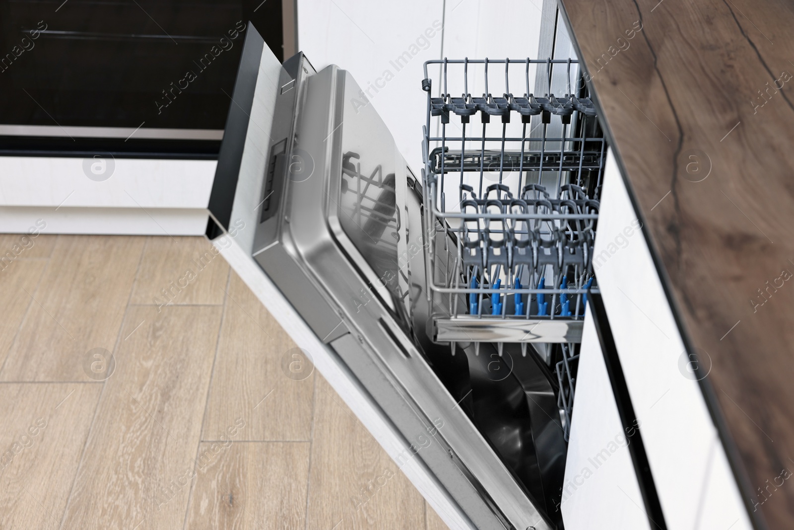 Photo of Built-in dishwasher with open door in kitchen