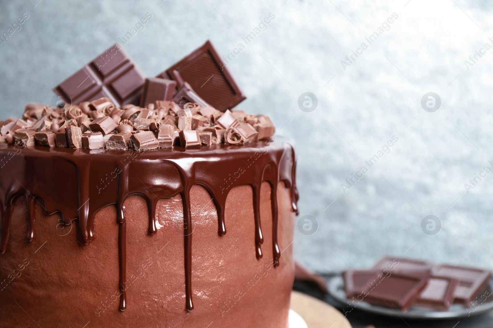 Photo of Freshly made delicious chocolate cake against grey background, closeup. Space for text