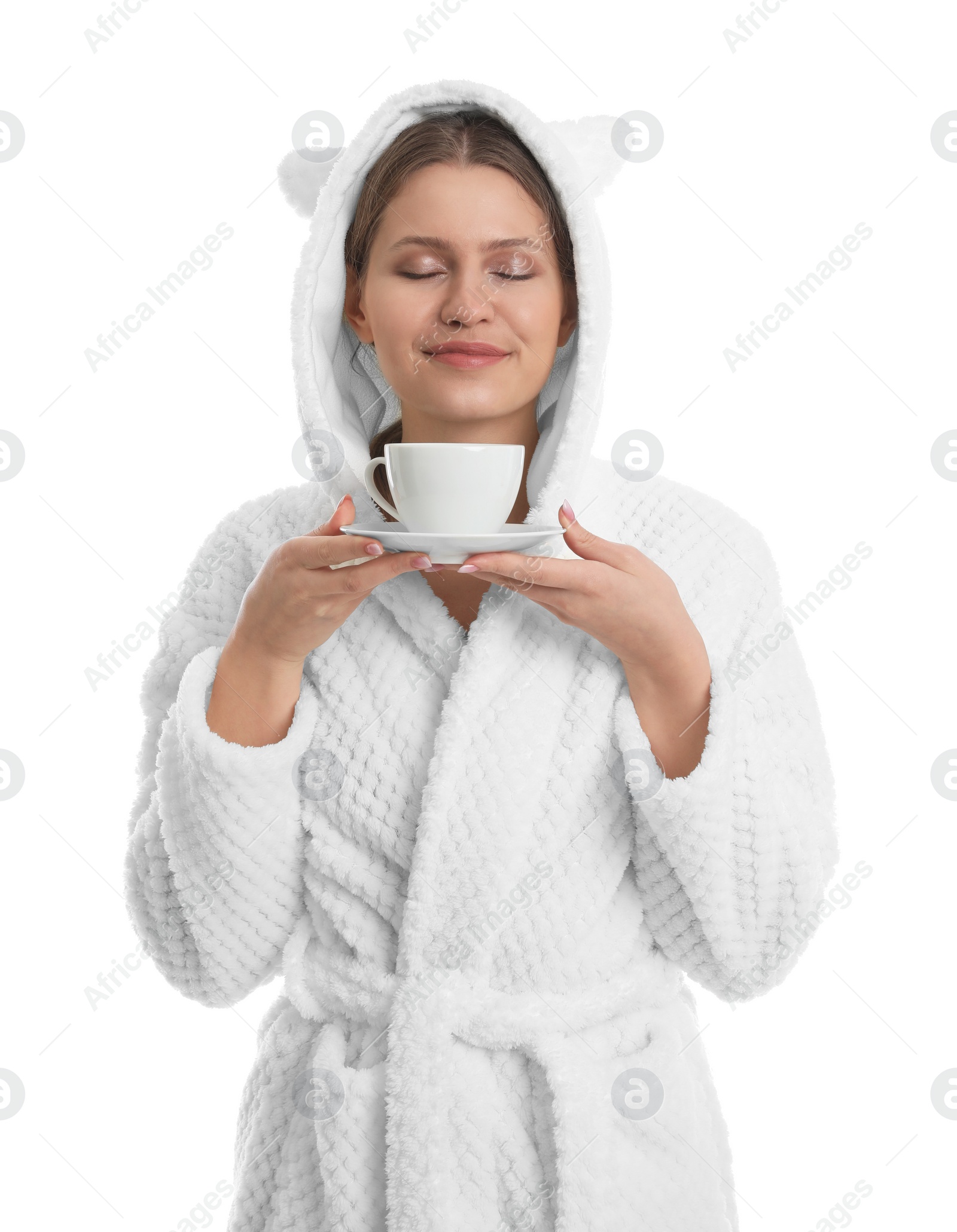 Photo of Young woman in bathrobe with cup of beverage on white background