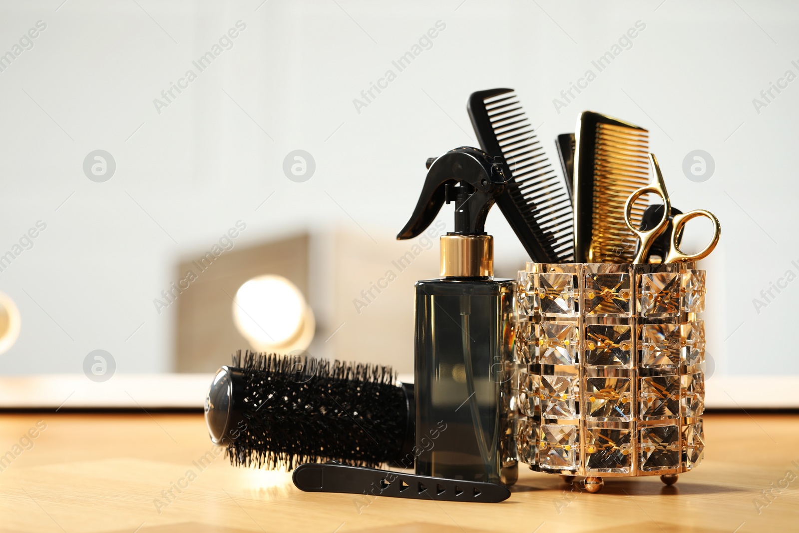 Photo of Set of hairdresser tools on table in salon, space for text