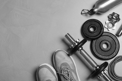 Photo of Gym equipment on light grey background, flat lay
